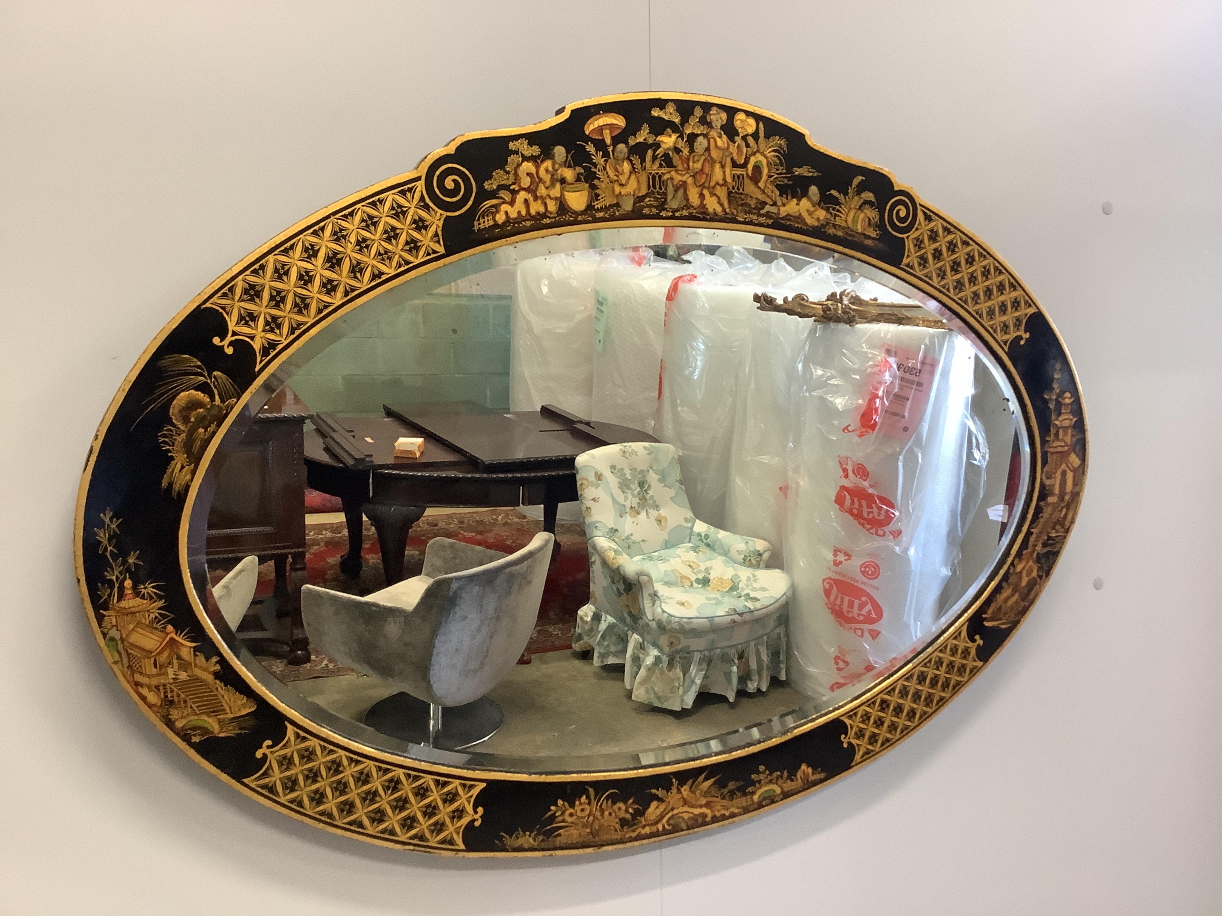 An early 20th century chinoiserie lacquer oval wall mirror, width 98cm, height 68cm. Condition - good